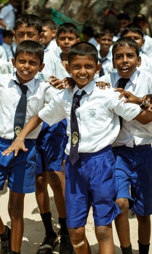 School children dressed in uniform have fun and play in the schoolyard. Wadduwa, Sri-Lanka.